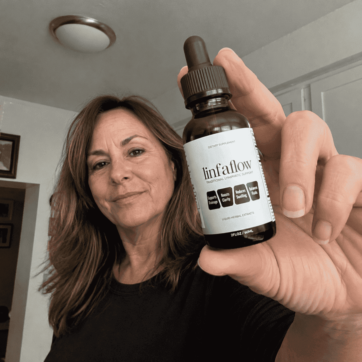 Frances holding a Linfaflow bottle close to camera